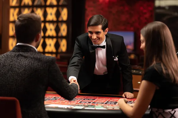 A woman in a luxurious green gown next to an ornate roulette wheel, capturing the upscale casino mood of 786BETT.